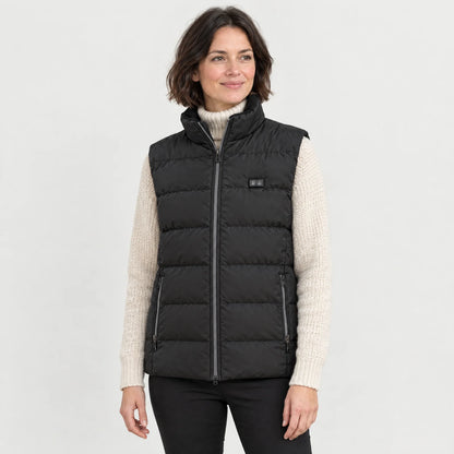 Woman wearing the heated vest 2.0 over a cream turtleneck